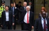 Britain's opposition Labour leader Jeremy Corbyn waves as he leaves the Labour Party headquarters in central London on June 9, 2017 after results in a snap general election show a hung parliament with Labour gains and the Conservative Party losing its majority. (AFP/Paul Ellis)