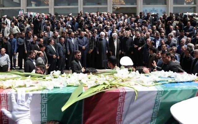 A handout picture provided by the Iranian Presidency on June 9, 2017 shows (C to R) Iran's President Hassan Rouhani, parliament speaker Ali Larijani and judiciary chief Sadeq Larijani standing among other officials the funeral of the victims of twin attacks in Tehran earlier in the week. (AFP/Iranian Presidency) A handout picture provided by the Iranian Presidency on June 9, 2017 shows (C to R) Iran's President Hassan Rouhani, parliament speaker Ali Larijani and judiciary chief Sadeq Larijani standing among other officials the funeral of the victims of twin attacks in Tehran earlier in the week. (AFP/Iranian Presidency)