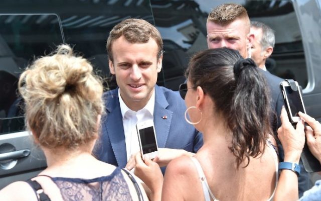French President Emmanuel Macron (C) meets people as he leaves his home in Le Touquet, northern France, on June 11, 2017, during the first round of France's legislative elections. (Philippe Huguen/AFP) French President Emmanuel Macron (C) meets people as he leaves his home in Le Touquet, northern France, on June 11, 2017, during the first round of France's legislative elections. (Philippe Huguen/AFP)