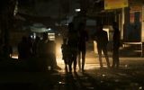 Palestinians walk on a street at the Al-Shati refugee camp in Gaza City during a power outage on June 11, 2017. (AFP Photo/Mahmud Hams)