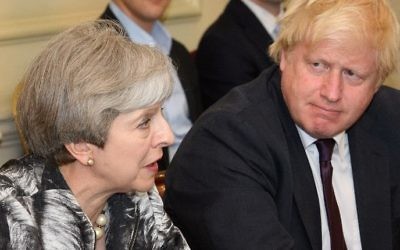 Britain's Prime Minister Theresa May, left, sits with Foreign Secretary Boris Johnson as she holds the first Cabinet meeting of her new team at 10 Downing Street in London on June 12, 2017, following the June 8 snap general election in which the ruling Conservatives lost their majority. (AFP Photo/Pool/Leon Neal)