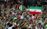 Illustrative: Supporters of the Iranian national soccer team cheer during the 2018 World Cup qualifying match between Iran and Uzbekistan at the Azadi Stadium in Tehran on June 12, 2017. (AFP Photo/Atta Kenare)