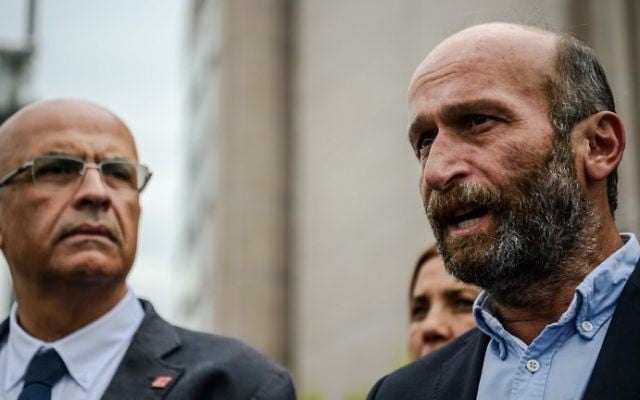 This file photo taken on September 21, 2016 shows Turkish Cumhuriyet Daily newspaper's Ankara bureau chief Erdem Gul (R), flanked by and former main opposition Republican People's Party MP Enis Berberoglu, as he talks to the media after his trial at Caglayan courthouse in Istanbul. (AFP PHOTO / OZAN KOSE) This file photo taken on September 21, 2016 shows Turkish Cumhuriyet Daily newspaper's Ankara bureau chief Erdem Gul (R), flanked by and former main opposition Republican People's Party MP Enis Berberoglu, as he talks to the media after his trial at Caglayan courthouse in Istanbul. (AFP PHOTO / OZAN KOSE)