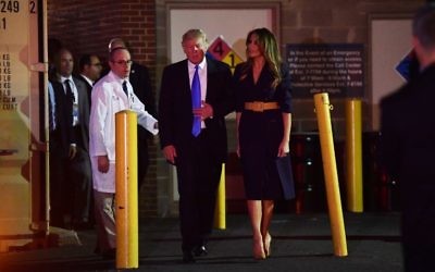 Dr. Ira Rabin (L) escorts US President Donald Trump and First Lady Melania Trump from MedStar Washington Hospital Center, June 14, 2017. (AFP Photo/Nicholas Kamm)