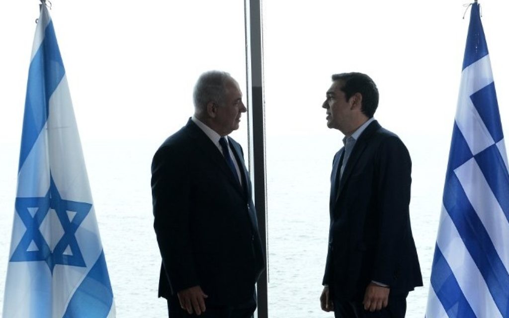Greek Prime Minister Alexis Tsipras (R) welcomes Prime Minister Benjamin Netanyahu (L) prior to a Greece-Israel-Cyprus summit for talks on offshore oil and gas in the eastern Mediterranean and environmental issues in Thessaloniki on June 15, 2017.  (AFP PHOTO / SAKIS MITROLIDIS)