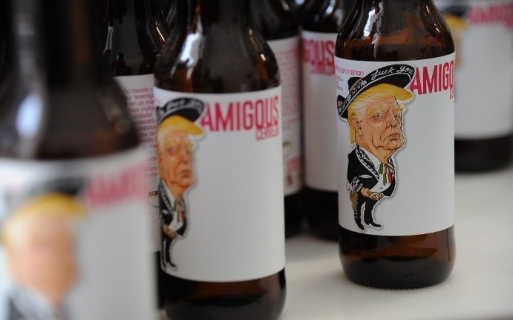 View of Amigous Craft Beer which bottle shows an image of US President Donald Trump wearing a Mariachi costume with a swastika, in Mexico City, on June 15, 2017. (AFP PHOTO / Bernardo Montoya)