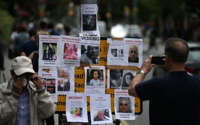 Posters and pictures of residents missing in the Grenfell Tower disaster, are posted near the Latymer Christian Centre in west London on June 16, 2017. (AFP/ Daniel LEAL-OLIVAS)
