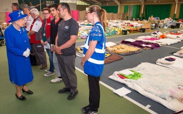 Britain's Queen Elizabeth II meets members of the community affected by the Grenfell Tower disaster during a visit to the Westway Sports Centre which is providing temporary shelter for those who have been made homeless, in west London on June 16, 2017. (AFP/Pool/Dominic Lipinski) Britain's Queen Elizabeth II meets members of the community affected by the Grenfell Tower disaster during a visit to the Westway Sports Centre which is providing temporary shelter for those who have been made homeless, in west London on June 16, 2017. (AFP/Pool/Dominic Lipinski)