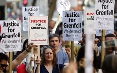 Demonstrators gather with placards outside the Department for Communities and Local Government in central London on June 16, 2017 to demand justice for those affected by the Grenfell Tower fire. (AFP/Tolga Akmen)