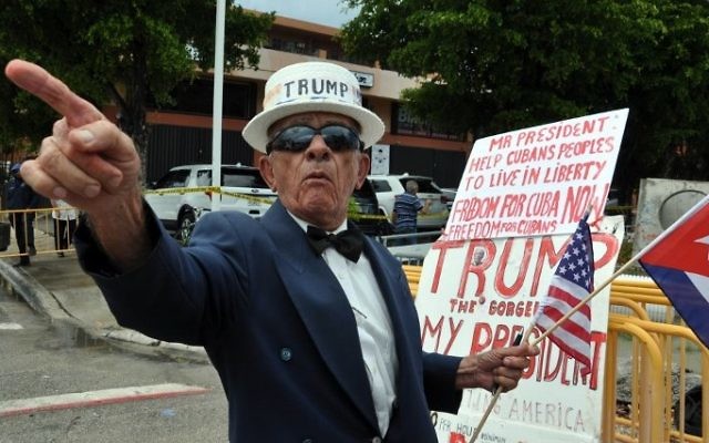 A man holds signs referencing US President Donald Trump's policy on Cuba, June 16, 2017 in Miami, Florida. (AFP PHOTO / Jose CARUCI) A man holds signs referencing US President Donald Trump's policy on Cuba, June 16, 2017 in Miami, Florida. (AFP PHOTO / Jose CARUCI)