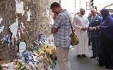 Britain's Prince Charles, Prince of Wales (3rd R) and Imam Mohammed Mahmoud (2nd L) visit floral tributes left close to the scene of the Finsbury Mosque attack in the Finsbury Park area of north London on June 21, 2017, following a car-ramming terror attack on pedestrians. (AFP/Pool/John Nguyen)