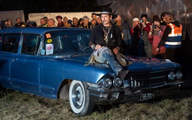 Actor Johnny Depp arrives to introduce his film, The Libertine, to the audience at 'Cineramageddon', the outdoor cinema venue, at the Glastonbury Festival of Music and Performing Arts on Worthy Farm near the village of Pilton in Somerset, South West England, on June 22, 2017. (AFP PHOTO / OLI SCARFF)
