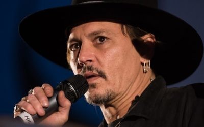 This file photo taken on June 22, 2017 shows actor Johnny Depp introducing his film 'The Libertine' to the audience at Cineramageddon, the outdoor cinema venue, at the Glastonbury Festival of Music and Performing Arts in Pilton in Somerset, South West England. (AFP/Oli Scarff)