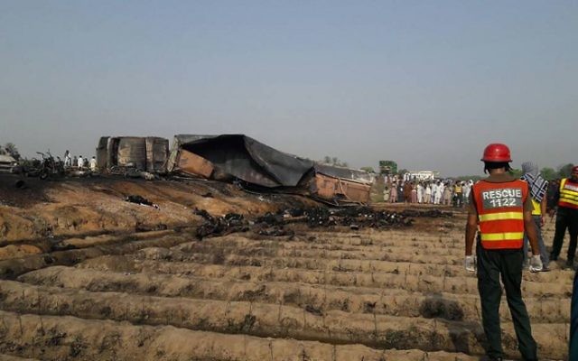 Pakistani rescue workers gather near burned bodies after an oil tanker caught fire following an accident on June 25, 2017. (AFP/ STR) Pakistani rescue workers gather near burned bodies after an oil tanker caught fire following an accident on June 25, 2017. (AFP/ STR)