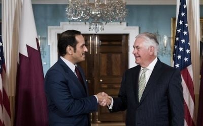 Qatar's Foreign Minister Mohammed bin Abdulrahman al-Thani, left, and US Secretary of State Rex Tillerson shake hands before a meeting at the US State Department in Washington, DC, June 27, 2017. (AFP/Brendan Smialowski)