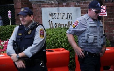 Members of Fairfax County Police stand guard at the entrance of Westfield Marriott Hotel where the Bilderberg Meeting takes place June 1, 2017 in Chantilly, Virginia. (Alex Wong/Getty Images/AFP)
