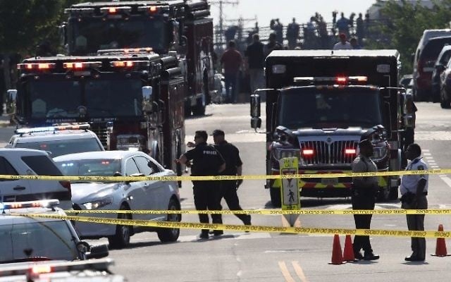 Investigators and emergency personnel gather adjacent to Eugene Simpson Field, the site where a gunman opened fire June 14, 2017 in Alexandria, Virginia. (Win McNamee/Getty Images/AFP)