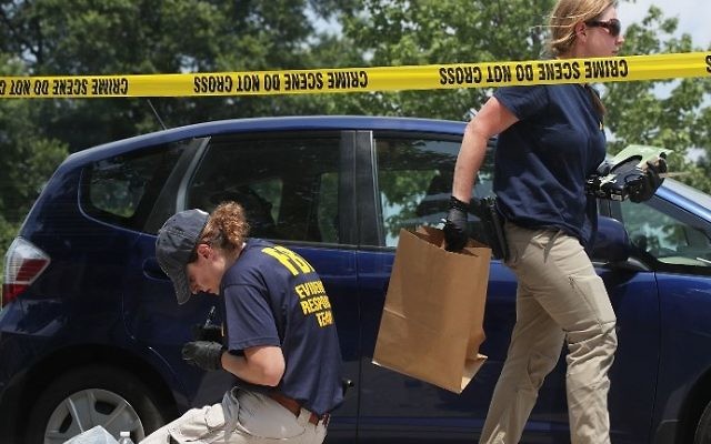 Members of the FBI Evidence Response Team collect evidence at the site of a shooting at Eugene Simpson Stadium Park June 14, 2017 in Alexandria, Virginia. (ALEX WONG / GETTY IMAGES NORTH AMERICA / AFP) Members of the FBI Evidence Response Team collect evidence at the site of a shooting at Eugene Simpson Stadium Park June 14, 2017 in Alexandria, Virginia. (ALEX WONG / GETTY IMAGES NORTH AMERICA / AFP)