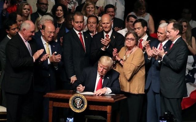 US President Donald Trump signs policy changes he is making toward Cuba at the Manuel Artime Theater in the Little Havana neighborhood on June 16, 2017 in Miami, Florida. (Joe Raedle/Getty Images/AFP) US President Donald Trump signs policy changes he is making toward Cuba at the Manuel Artime Theater in the Little Havana neighborhood on June 16, 2017 in Miami, Florida. (Joe Raedle/Getty Images/AFP)