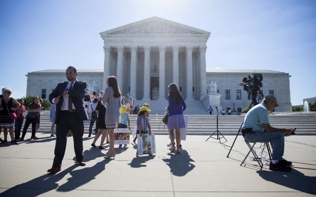 Illustrative: Outside the US Supreme Court, after it was announced that the court will allow a limited version of US President Donald Trump's travel ban to take effect, June 26, 2017, in Washington, DC. (Eric Thayer/Getty Images/ AFP) Illustrative: Outside the US Supreme Court, after it was announced that the court will allow a limited version of US President Donald Trump's travel ban to take effect, June 26, 2017, in Washington, DC. (Eric Thayer/Getty Images/ AFP)