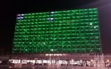 Tel Aviv City Hall lit in green to protest the US decision to withdraw from the Paris climate change accord. (Ron Huldai via Facebook)