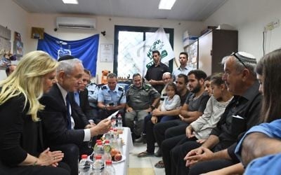 Prime Minister Benjamin Netanyahu (2l) and his wife Sara (l) pay a condolence visit to the home of slain Border Police officer Hadas Malka on June 18, 2017. (Koby Gideon/GPO)