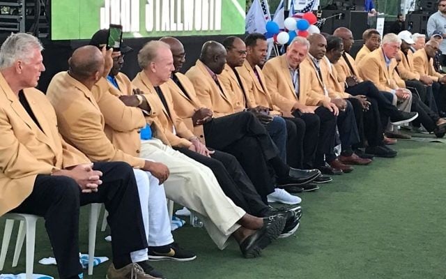 In this Sunday June 18, 2017 photo, 18 members of the Pro Football Hall of Fame are introduced by HOF President David Baker at Kraft Family Stadium in Jerusalem. (Jacob Magid/Times of Israel)