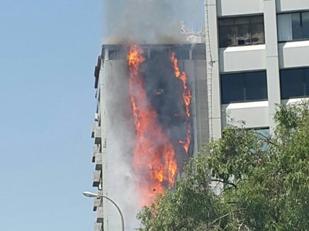 A fire rages in a 15-story apartment building in Ramat Gan, June 13, 2016. (Screen capture: Channel 2) A fire rages in a 15-story apartment building in Ramat Gan, June 13, 2016. (Screen capture: Channel 2)