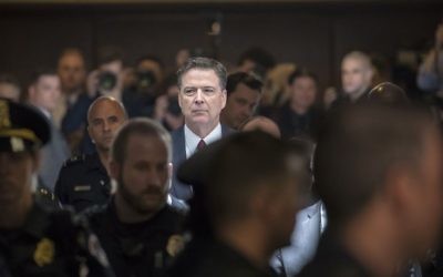 Former FBI director James Comey walks through a corridor on the way to a secure room to continue his testimony to the Senate Select Committee on Intelligence, on Capitol Hill in Washington, Thursday, June 8, 2017. (AP Photo/J. Scott Applewhite)