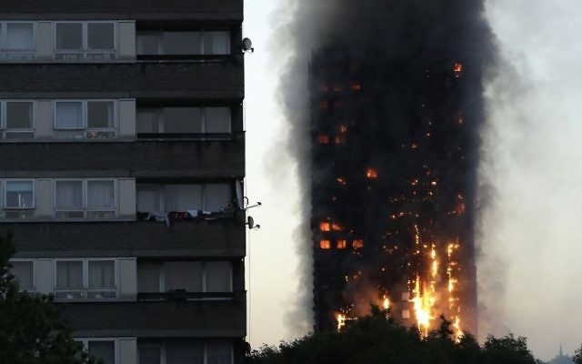Smoke and flames rise from the Grenfell Tower apartment building in West London, June 14, 2017. (AP/Matt Dunham) Smoke and flames rise from the Grenfell Tower apartment building in West London, June 14, 2017. (AP/Matt Dunham)