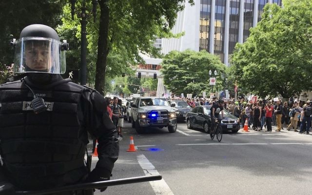 In this Sunday, June 4, 2017 file photo, thousands of protesters gather in Portland, Ore., for competing rallies following last month's fatal stabbing of two men on a light-rail train by a man police say was shouting anti-Muslim slurs. (AP Photo/Kristena Hansen) In this Sunday, June 4, 2017 file photo, thousands of protesters gather in Portland, Ore., for competing rallies following last month's fatal stabbing of two men on a light-rail train by a man police say was shouting anti-Muslim slurs. (AP Photo/Kristena Hansen)