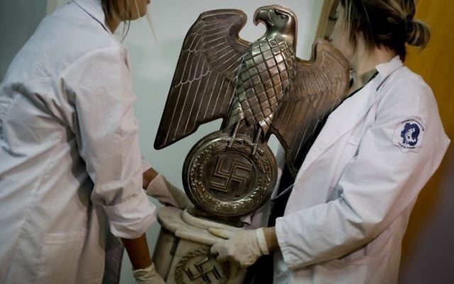Members of the federal police carry a Nazi statue at the Interpol headquarters in Buenos Aires, Argentina, June 16, 2017. (AP/Natacha Pisarenko) Members of the federal police carry a Nazi statue at the Interpol headquarters in Buenos Aires, Argentina, June 16, 2017. (AP/Natacha Pisarenko)
