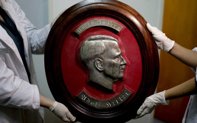Members of the federal police show a bust relief portrait of Nazi leader Adolf Hitler at the Interpol headquarters in Buenos Aires, Argentina, June 16, 2017. (AP/Natacha Pisarenko) Members of the federal police show a bust relief portrait of Nazi leader Adolf Hitler at the Interpol headquarters in Buenos Aires, Argentina, June 16, 2017. (AP/Natacha Pisarenko)