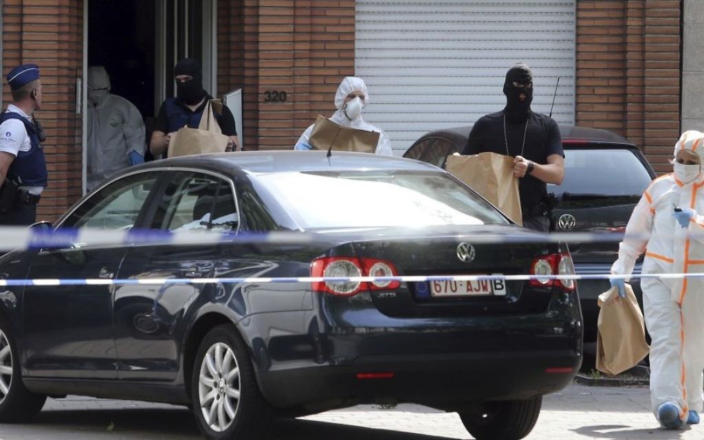 Police and forensic officers remove items during a house search in the Molenbeek district of Brussels on Wednesday, June 21, 2017. (AP Photo/Francois Walschaerts)