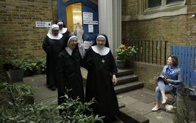 Benedictine nuns from Tyburn Convent leave after voting in Britain's general election at a polling station in St John's Parish Hall, London, Thursday, June 8, 2017 (AP Photo/Matt Dunham)