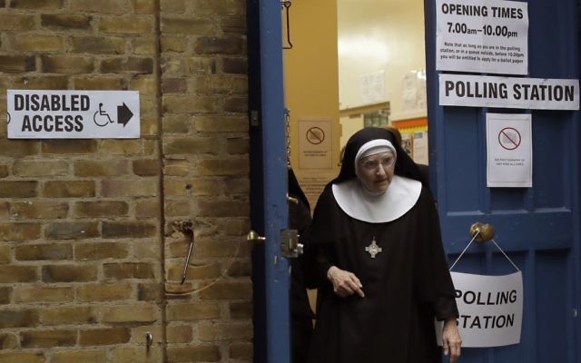 A Benedictine nun from Tyburn Convent leaves after voting in Britain's general election at a polling station in St John's Parish Hall, London, June 8, 2017. (AP/Matt Dunham) 