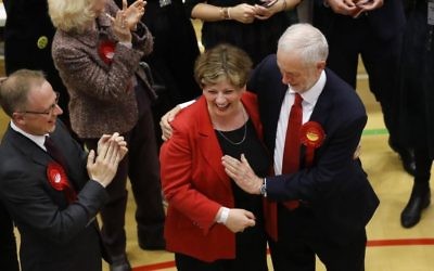 Britain's Labour Party leader Jeremy Corbyn, right, tries to high-five with Labour's Emily Thornberry after arriving for the declaration at his constituency in London, Friday, June 9, 2017.  (AP Photo/Frank Augstein)