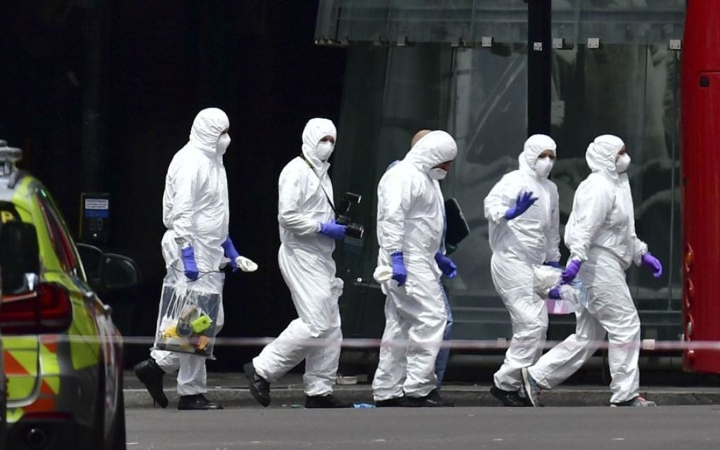 Police forensic officers outside Borough Market, London, Sunday June 4, 2017, near the scene of Saturday night's terrorist incident. (Dominic Lipinski/PA via AP)