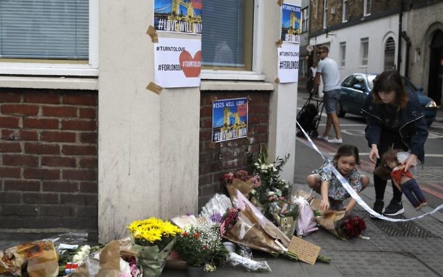 A small child lays flowers at a corner tribute in the London Bridge area of London, Sunday, June 4, 2017. (AP/Frank Augstein) A small child lays flowers at a corner tribute in the London Bridge area of London, Sunday, June 4, 2017. (AP/Frank Augstein)