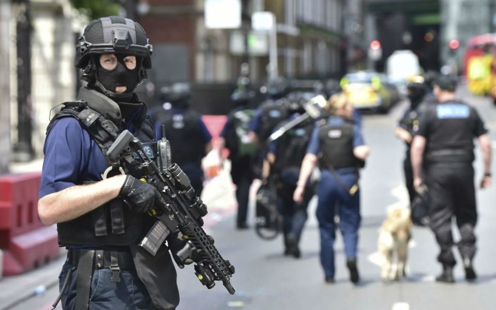 Armed police on St. Thomas Street, London, on June 4, 2017, near the scene of a terror attack on London Bridge and at the capital's Borough Market. (Dominic Lipinski/PA via AP)