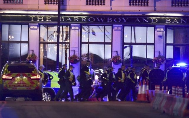 Police officers on Borough High Street during at least one an incident on London Bridge in London, June 3, 2017. (Dominic Lipinski/PA via AP)