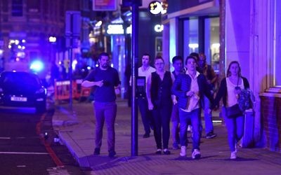 People run down Borough High Street as police deal with a "major incident" at London Bridge in London, June 3, 2017. (Dominic Lipinski/PA via AP)