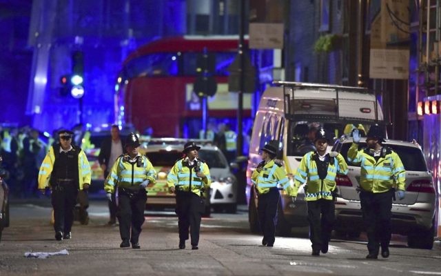 Police officers on Borough High Street during a terror attack on London Bridge in London, June 3, 2017. (Dominic Lipinski/PA via AP)