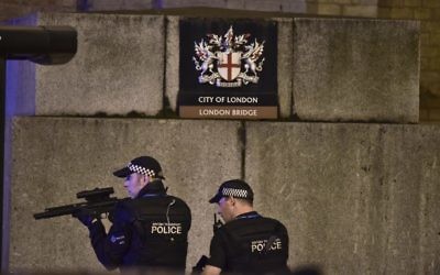 An armed police officer looks through his weapon on London Bridge in London, June 3, 2017. (Dominic Lipinski/PA via AP)