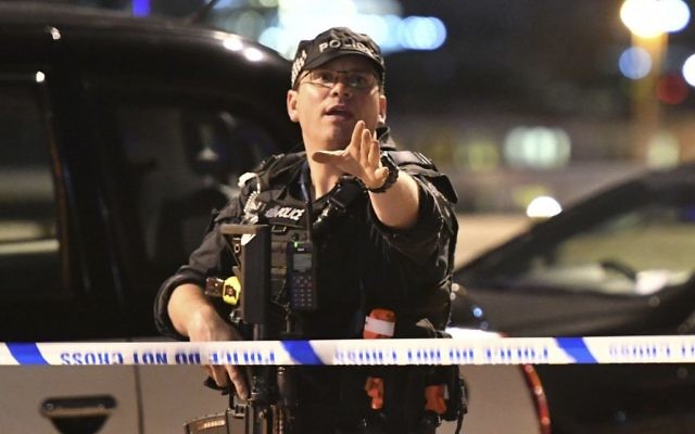 An armed police officer gestures after an incident in central London, June 3, 2017. (Dominic Lipinski/PA via AP) An armed police officer gestures after an incident in central London, June 3, 2017. (Dominic Lipinski/PA via AP)