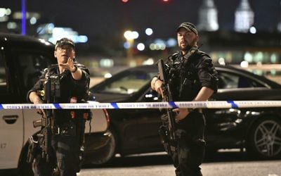Armed police officers stand guard on London Bridge in central London, Saturday, June 3, 2017. (Dominic Lipinski/PA via AP)