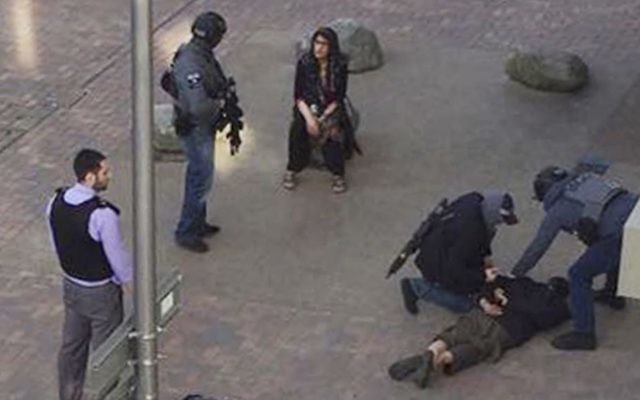A person, on ground, being detained by police at Elizabeth Fry apartments in Barking, East London, which officers raided Sunday June 4, 2017, following Saturday's terror attack at London Bridge and Borough Market. (Furqan Nabi/PA via AP)