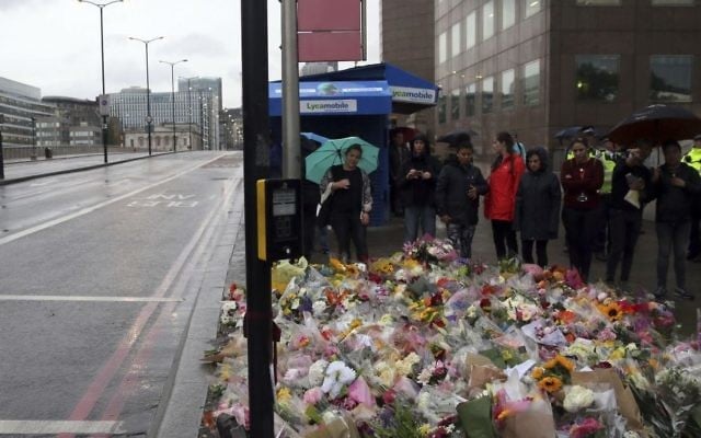 People lay flowers for victims of Saturday's attack on London Bridge, Monday, June 5, 2017 (AP Photo/Tim Ireland)