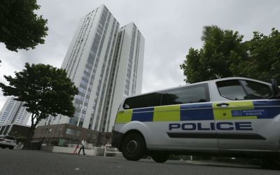 A police van drives past the Chalcots Estate in the borough of Camden, north London, June 25, 2017. (AP Photo/Tim Ireland)