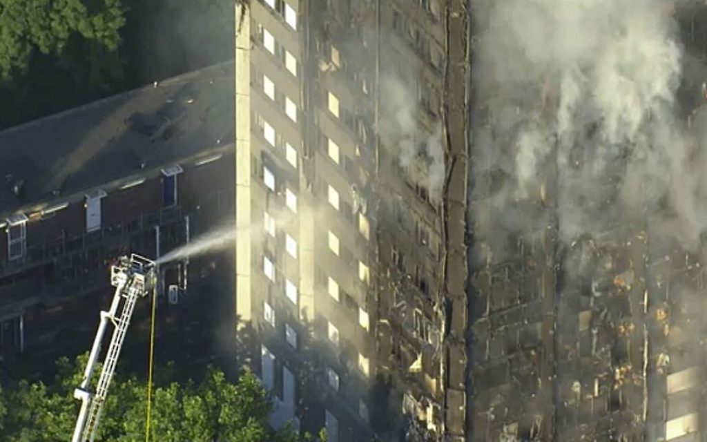 In this photo taken from video, smoke rises from a high-rise apartment building on fire in London, Wednesday, June 14, 2017. (Sky News via AP)